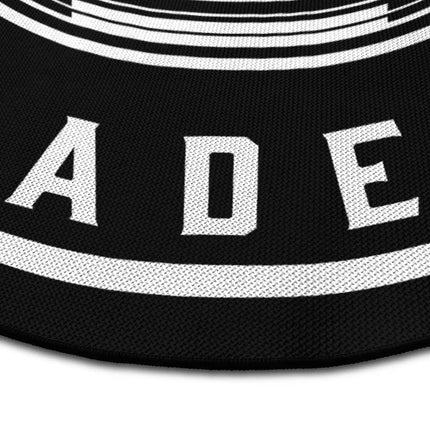 Close up of astronaut academy round rug Jet Black edge showing woven polyester detail
