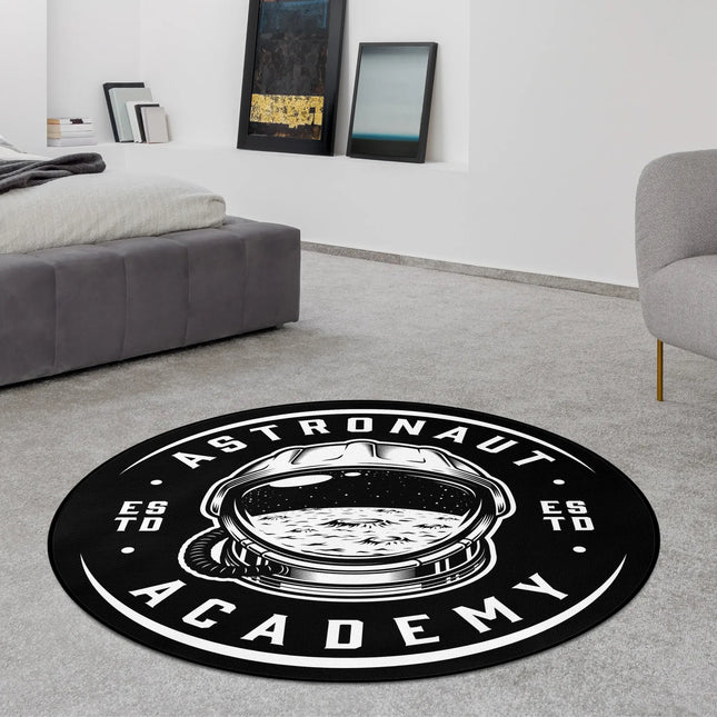 Astronaut academy graphic round rug with monochrome astronaut helmet artwork and academy style typography styled in a modern bedroom with Jet Black edge finish