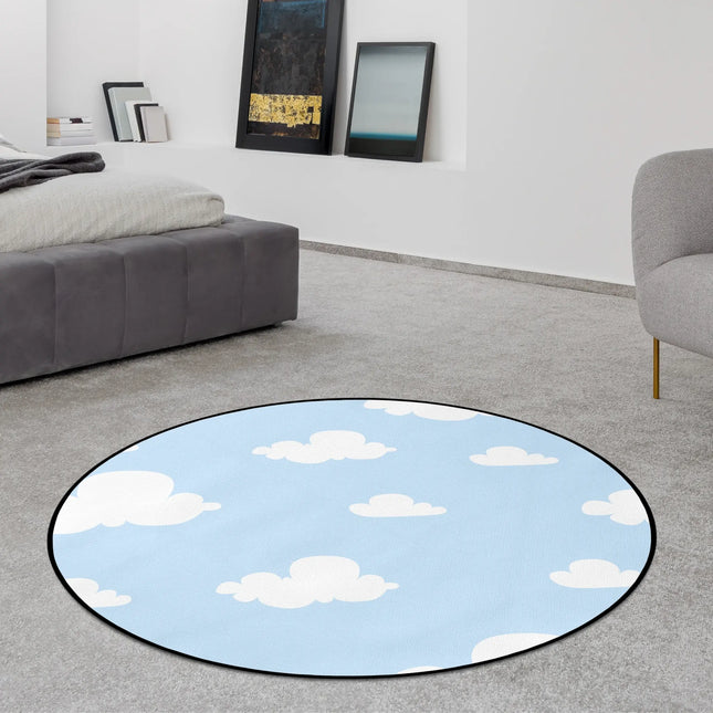 Cloud nine graphic round rug with white cartoon clouds across a light blue sky background styled in a modern bedroom with Jet Black edge finish