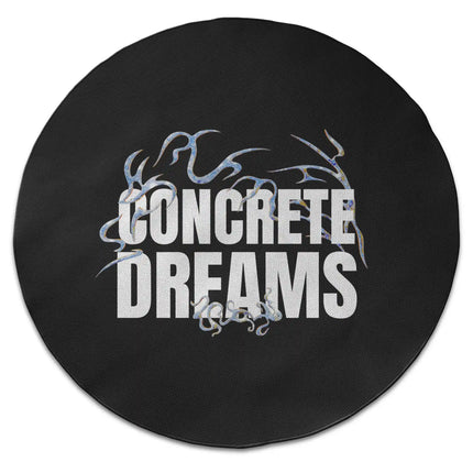 Black concrete dreams graphic round rug with oversized monochrome typography shown from above on white background with Jet Black edge finish