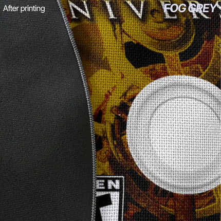 Close-up of fog grey rug edge showing plain grey fabric next to a printed game disc design in gold and brown, with a circular magnified inset of the grey fabric weave.
