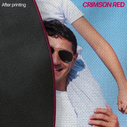 Close-up of custom rug edge showing crimson red fabric backing next to a printed photo of a person in sunglasses, with the red stitched seam visible.