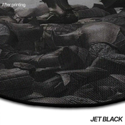 Close-up of a jet black rug edge showing a dark, moody printed image of a gaming character design.