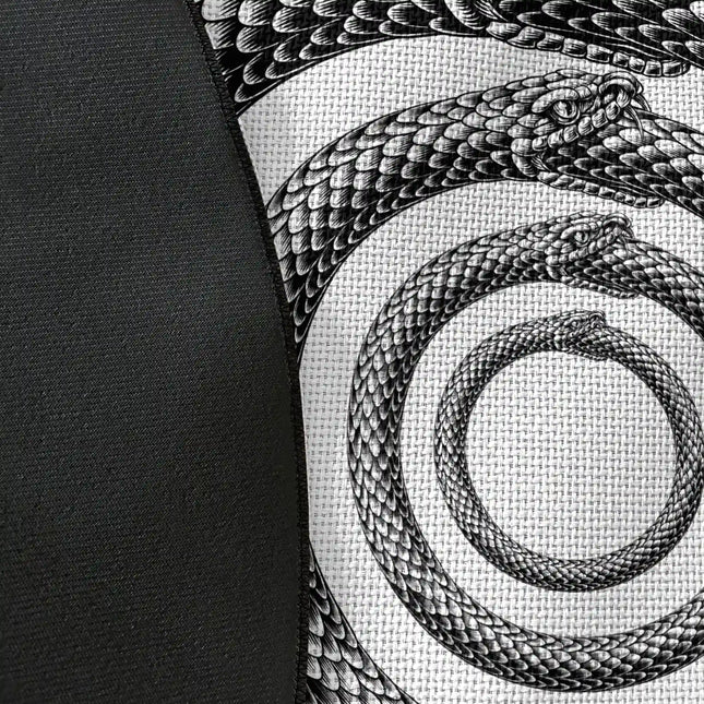 Close up of woven polyester material on Endless Coil graphic round rug with Jet Black edge showing serpent spiral artwork and print texture