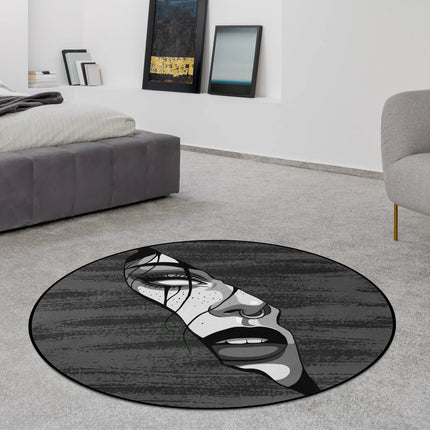 Fragmented soul graphic round rug with distorted monochrome face artwork styled in a modern bedroom with Jet Black edge finish