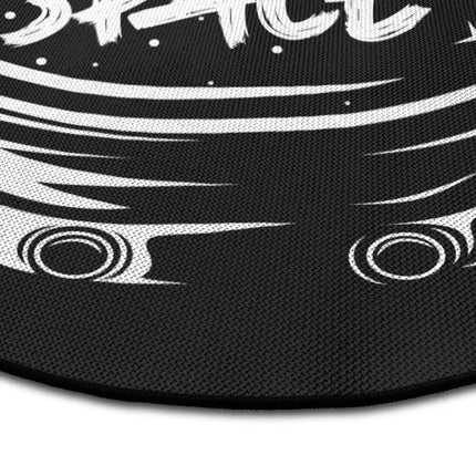 Close up of Give Me More Space graphic round rug Jet Black edge showing woven polyester texture