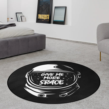 Give Me More Space graphic round rug with astronaut artwork styled in a modern bedroom with Jet Black edge finish