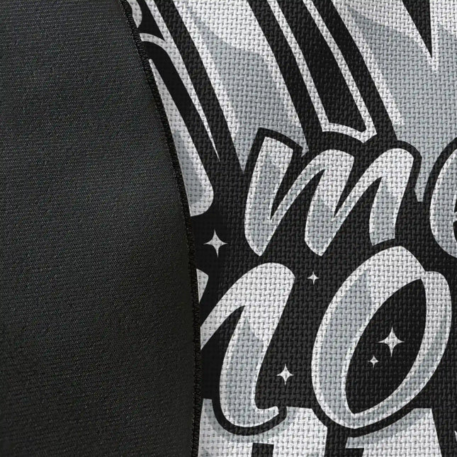 Close up of woven polyester material on typography graphic round rug with “Give Me More Space” text showing detailed print texture and contrast with Jet Black edge