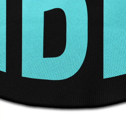 Close up of good vibes round rug Jet Black edge showing woven polyester detail