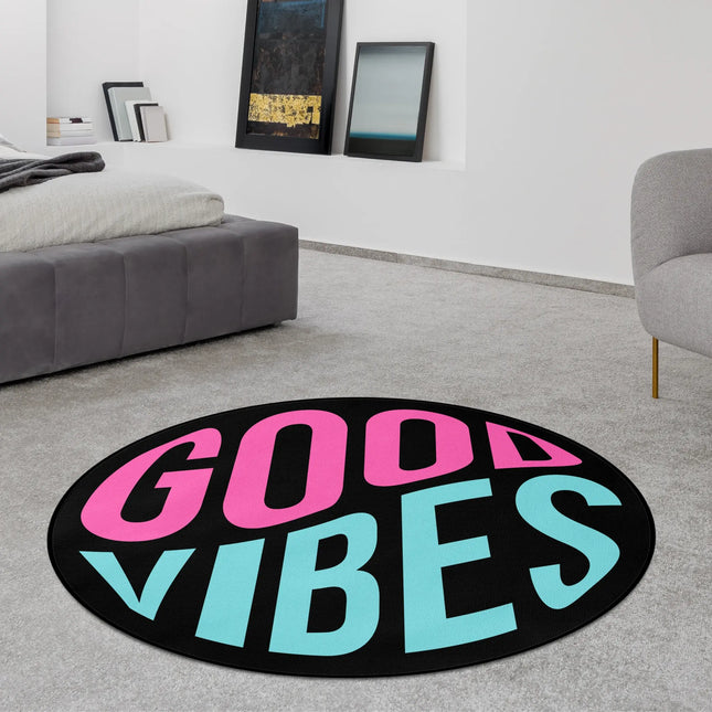 Good vibes graphic round rug with bold pink and aqua blue neon typography styled in a modern bedroom with Jet Black edge finish