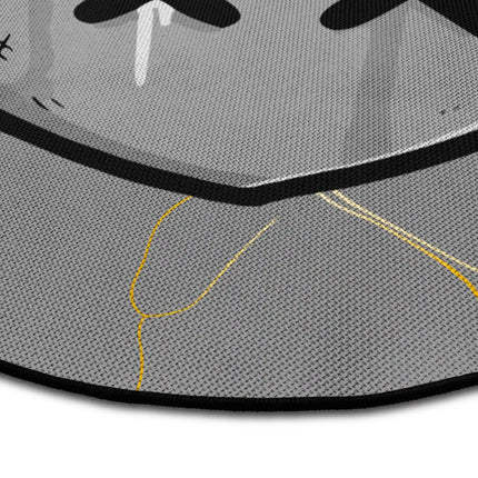 Close up of Heartless graphic round rug with stabbed heart artwork showing Jet Black edge and woven polyester texture