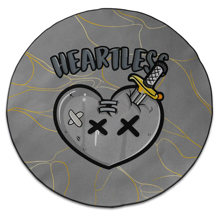 Heartless graphic round rug with stabbed heart artwork and Jet Black edge finish shown from above on white background
