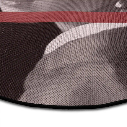Close up of Hidden Gaze graphic round rug with distorted portrait artwork showing Jet Black edge and woven polyester texture