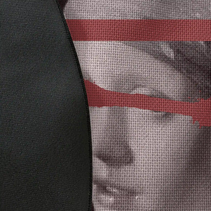 Close up of woven polyester material on Hidden Gaze graphic round rug with Jet Black edge showing distorted portrait artwork and print texture