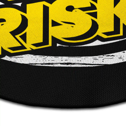 Close up of Keep Taking Risk graphic round rug Jet Black edge showing woven polyester detail