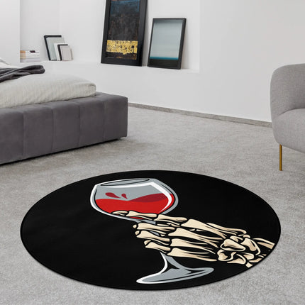 Black last sip graphic round rug with skeleton hand holding red wine glass styled in a modern bedroom with Jet Black edge finish