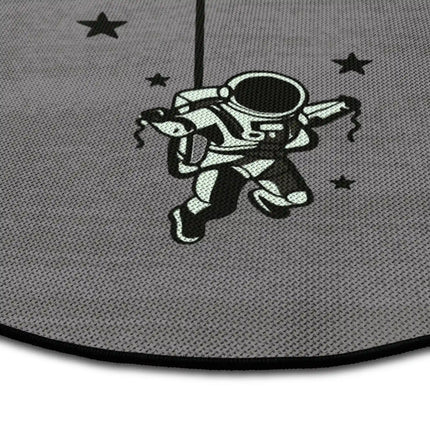 Close up of lost in orbit graphic round rug with floating astronaut artwork showing Jet Black edge and woven polyester texture