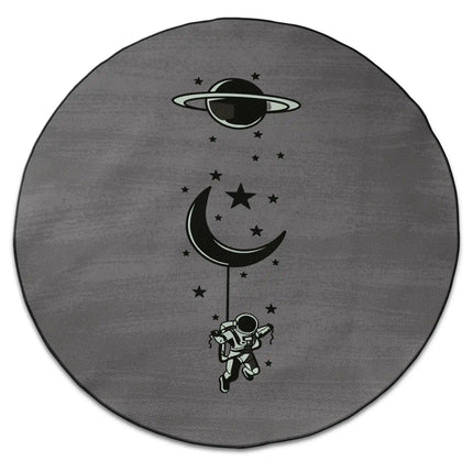 Lost in orbit graphic round rug with floating astronaut, crescent moon and Jet Black edge finish shown from above on white background
