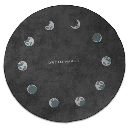 Lunar cycle graphic round rug with moon phase artwork and Jet Black edge finish shown from above on white background