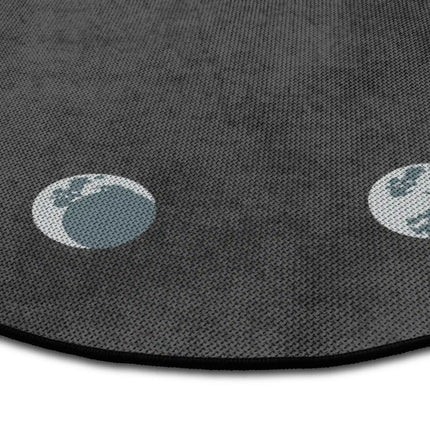 Close up of lunar cycle graphic round rug with moon phase artwork showing Jet Black edge and woven polyester texture
