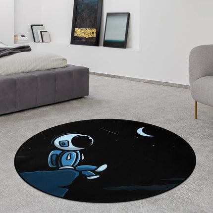 Black midnight drifter graphic round rug with astronaut resting beneath a crescent moon and stars styled in a modern bedroom with Jet Black edge finish