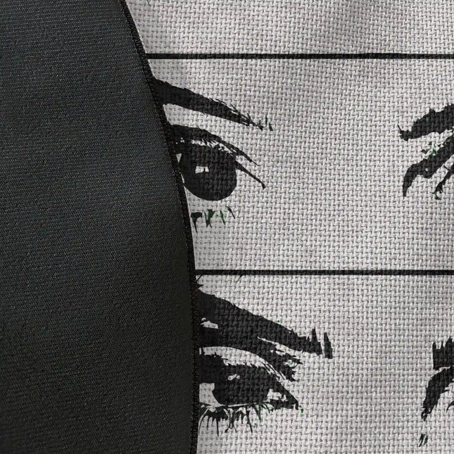 Close up of woven polyester material on mind reader graphic round rug with Jet Black edge showing fragmented eye artwork and print texture