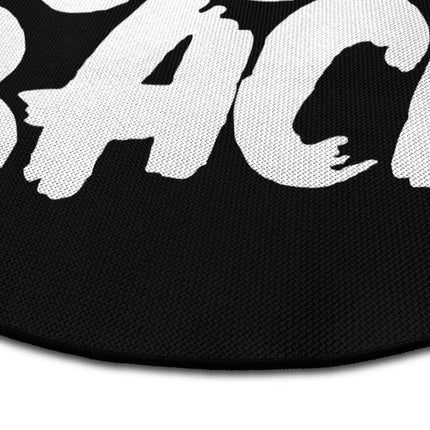 Close up of never look back graphic round rug Jet Black edge showing woven polyester detail