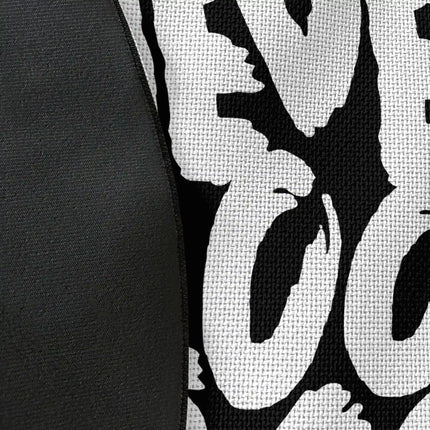 Close up of woven polyester material on never look back graphic round rug with Jet Black edge finish showing print texture
