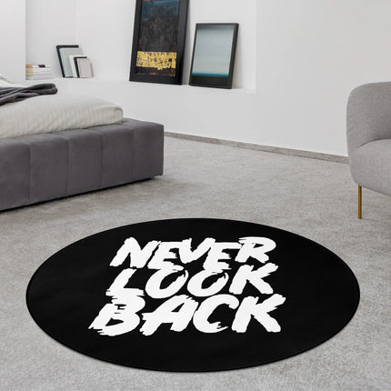Black never look back graphic round rug styled in a modern bedroom with Jet Black edge finish