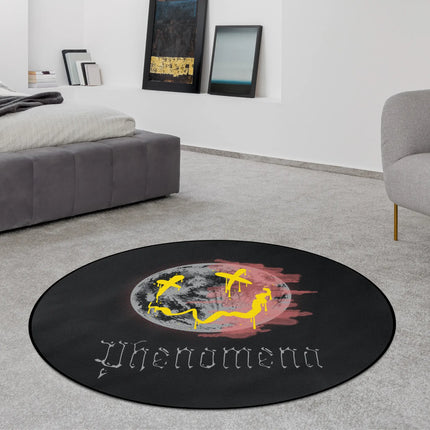 Black phenomena graphic round rug with distorted moon face and yellow graffiti style accents styled in a modern bedroom with Jet Black edge finish