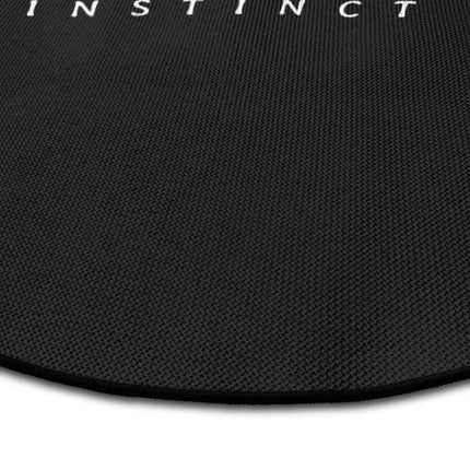 Close up of primitive instinct graphic round rug Jet Black edge showing woven polyester detail