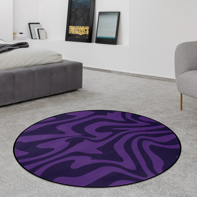 Purple haze round rug with flowing abstract wave pattern in deep violet tones styled in a modern bedroom with Jet Black edge finish