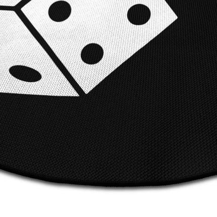 Close up of roll the dice graphic round rug with oversized dice artwork showing Jet Black edge and woven polyester texture