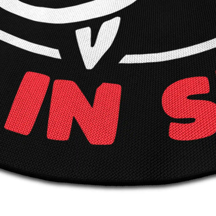 Close up of Speak Good Or Remain Silent graphic round rug Jet Black edge showing woven polyester texture