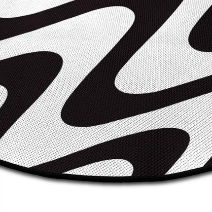 Close up of static flow round rug Jet Black edge showing woven polyester detail