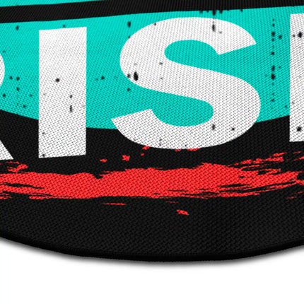 Close up of take the risk round rug Jet Black edge showing woven polyester detail