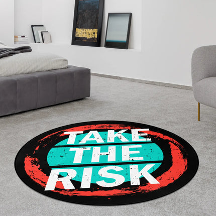 Black take the risk graphic round rug with distressed typography, teal centre and red brushstroke circle styled in a modern bedroom with Jet Black edge finish