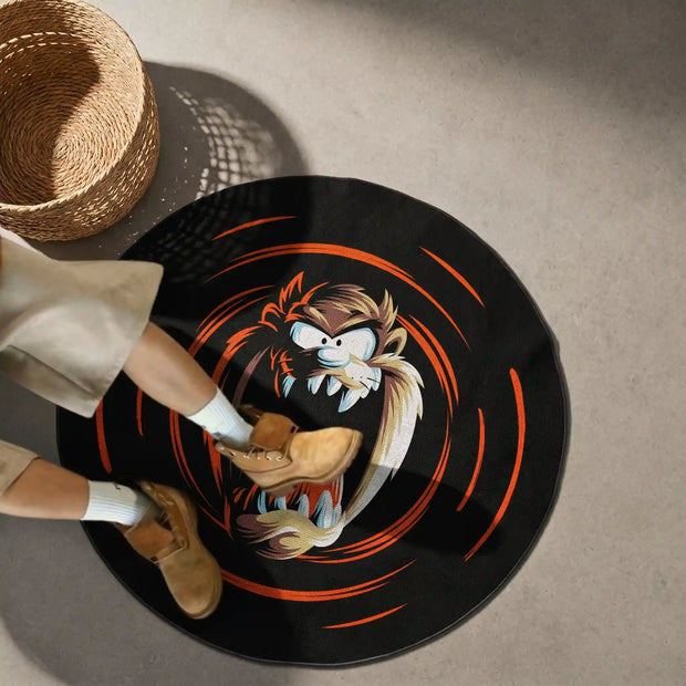 Round black round rug featuring a fierce cartoon Tasmanian Devil surrounded by orange swirl graphics, shown in a modern room.