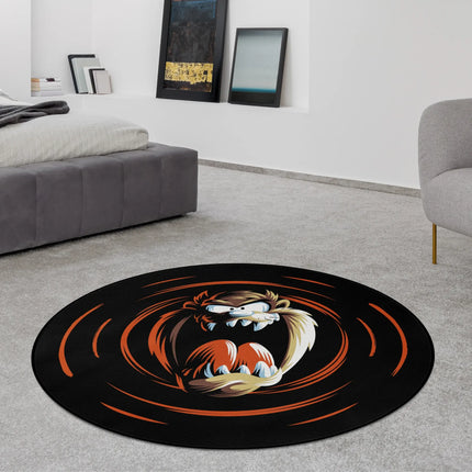 Black Tasmanian Devil graphic round rug with cartoon character and swirling orange motion design styled in a modern bedroom with Jet Black edge