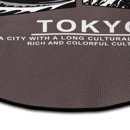 Close up of tokyo noir graphic round rug with Japanese wave artwork showing Jet Black edge and woven polyester texture