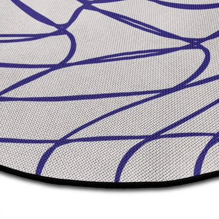 Close up of Warp Grid abstract round rug with warped optical line artwork showing Jet Black edge and woven polyester texture