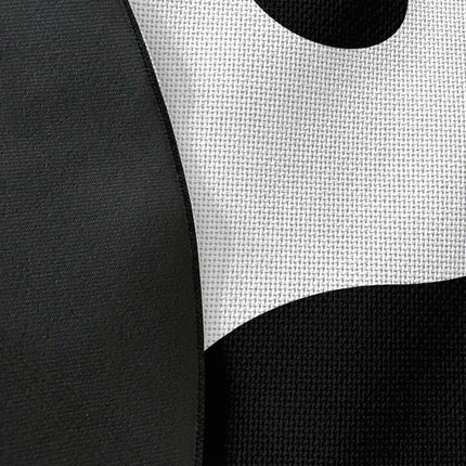Close up of woven polyester material on yin yang graphic round rug with Jet Black edge finish showing black and white symbol print detail