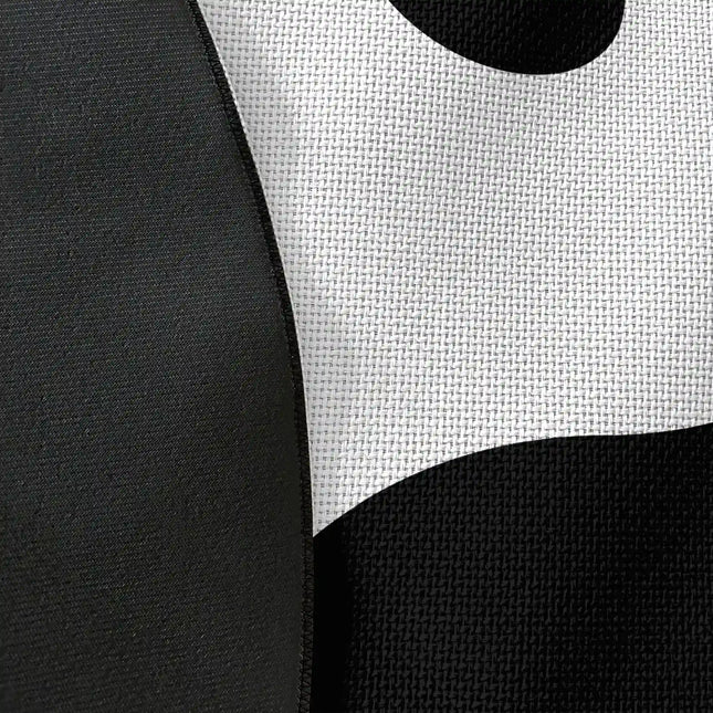 Close up of woven polyester material on yin yang graphic round rug with Jet Black edge finish showing black and white symbol print detail