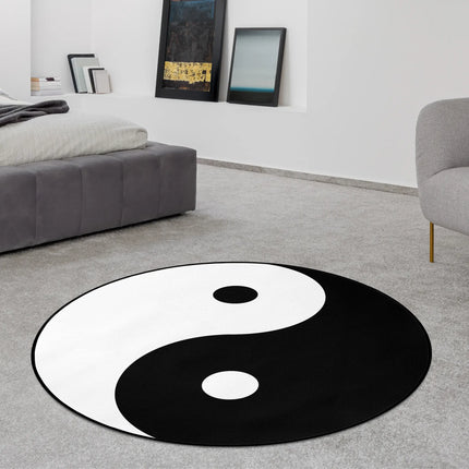 Yin yang graphic round rug with bold black and white balance symbol styled in a modern bedroom with Jet Black edge finish